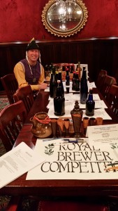 Lord Terafan and a table covered with brewing entries and the prizes for Royal Brewer
